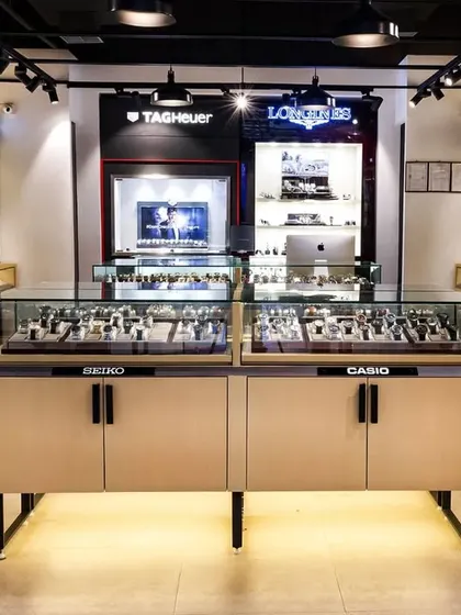 The interior of the Ethos store, featuring custom-designed display counters for brands like Seiko and Casio. The layout is designed to guide customers through the different brand collections.