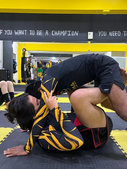 A fighter works to pass his opponent's guard. This is a common and crucial scenario in BJJ and submission grappling.