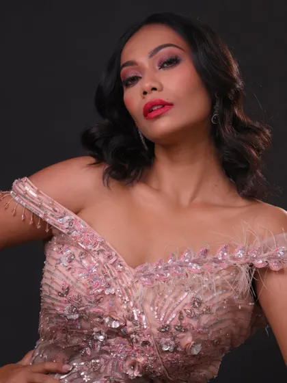 Another portrait showing the dramatic eye makeup and confident pose.
