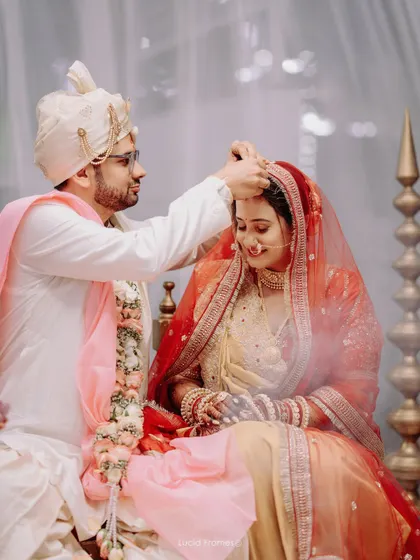 The groom applies sindoor to the bride's parting, a deeply significant and emotional ritual.