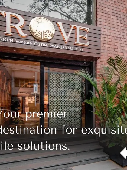 This is the entrance to one of my showrooms, your premier destination for exquisite tile solutions. The warm brick exterior and lush plants create a welcoming first impression for your design journey.