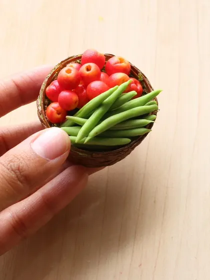 A basket of miniature tomatoes and green beans, a beautiful creation from the vegetables course.