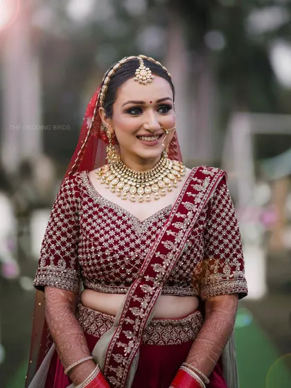 A candid shot of the bride during her wedding ceremony. The soft flare of light adds a dreamy quality to the image, highlighting her happy and radiant expression.