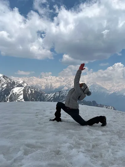 A deep lunge in Anjaneyasana, or crescent moon pose, opening the heart towards the Himalayan sky. Practicing on snow adds a unique challenge, demanding complete focus and connection to the body.