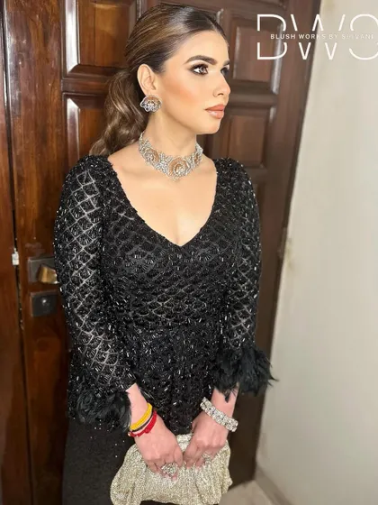 A close-up of the client's sleek ponytail, showing the clean lines and polished finish. This hairstyle is perfect for a glamorous evening event.