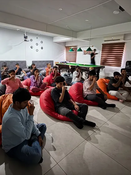 Even the break room can become a space for wellness. Here, employees at Skills Outsource use beanbags for a comfortable and relaxed pranayama (breathing) practice.