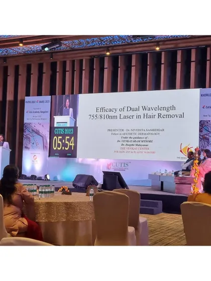 On stage during my presentation on laser hair removal, discussing the science behind achieving effective and long-lasting results.