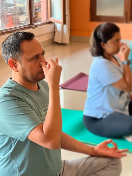 Here, a participant is fully engaged in a pranayama exercise during a class. His focused expression shows the deep concentration that breathwork cultivates, helping to quiet the mind and improve focus.