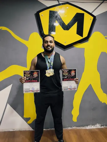 Celebrating success right here at the gym. Our champion athlete, Srinivas, proudly displays his World Cup diplomas and medals, inspiring the entire MultiFit community.