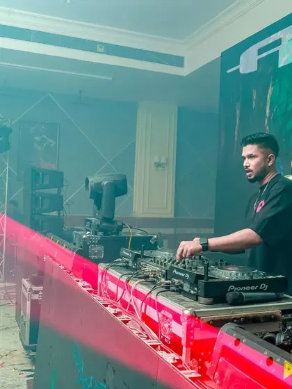 A shot during soundcheck, with red light beams highlighting the DJ console. Preparation is key to a flawless performance.