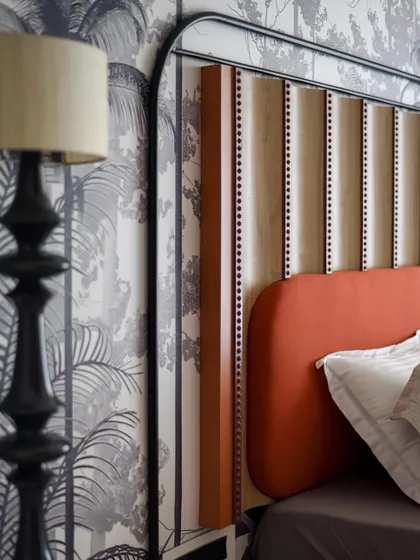 A close-up of the headboard, showing the intricate carvings and upholstery details. This piece is a perfect example of our commitment to bespoke craftsmanship.