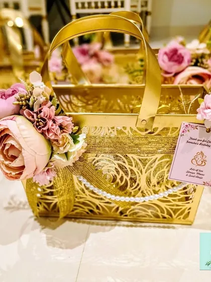 A closer look at the intricate laser-cut details on the metal housewarming favor baskets. The floral accent and personalized tag add a final touch of elegance.