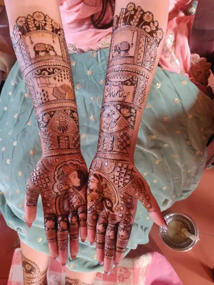 A full theme henna for bride Ashritha, showcasing portraits of the bride and groom, as well as other scenes from their love story.