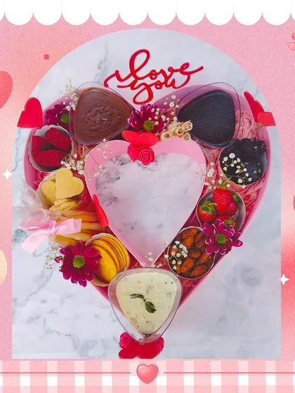 A customized heart-shaped gourmet hamper for Valentine's Day. This lavish gift includes a variety of sweet and savory treats, all presented in a beautiful heart-shaped box.