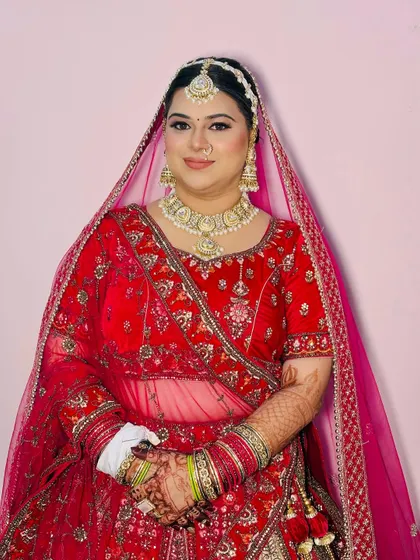 The bride looking directly at the camera, showcasing the symmetry and precision of the makeup application.