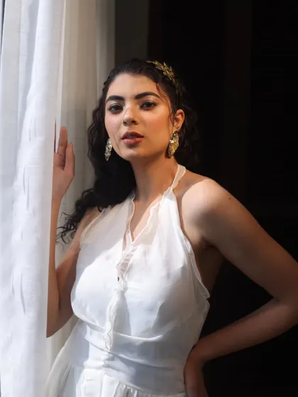 A beautiful, ethereal look for a photoshoot. The makeup is minimal and fresh, focusing on glowing skin and a soft lip tint.