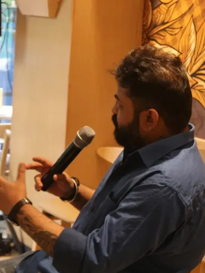 A side profile captures author Oninthough mid-sentence, emphasizing the storytelling aspect of our literary events.