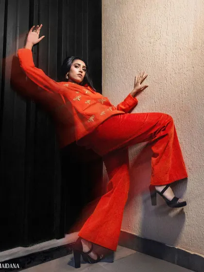 A bold, red corduroy suit with custom embroidery, showing the versatility of our Indo-Western designs.
