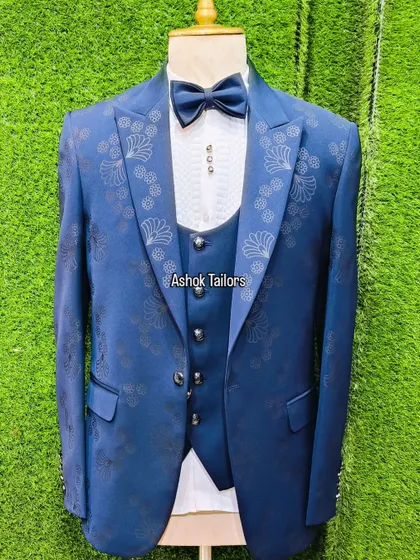 A royal blue three-piece suit with a subtle floral pattern on the jacket. It's a very elegant and stylish choice.