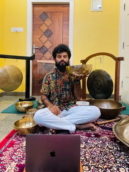 My online and in-person setup for teaching sound healing, surrounded by gongs and bowls.