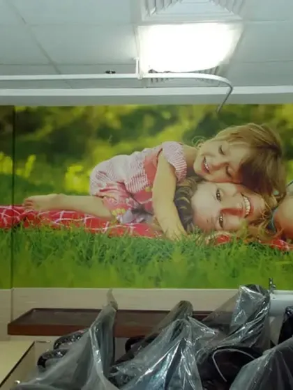 A heartwarming, custom photo mural can make a clinical space feel more personal and reassuring. This installation in a healthcare facility uses a positive family image to create a warm and comforting atmosphere for patients.