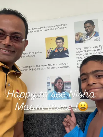 One of our young swimmers, Ishaan, proudly points to a picture of "Nisha Ma'am" on a display of Indian swimmers. It's wonderful to see our students feeling inspired.
