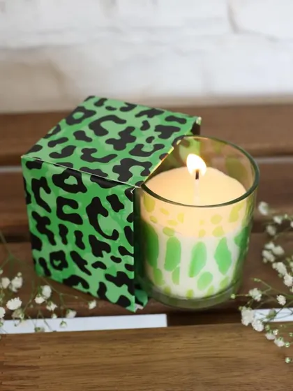 A bold and playful scented candle with a bright green leopard print. This piece is designed to add a pop of color and personality to any room, while filling it with a delightful fragrance.