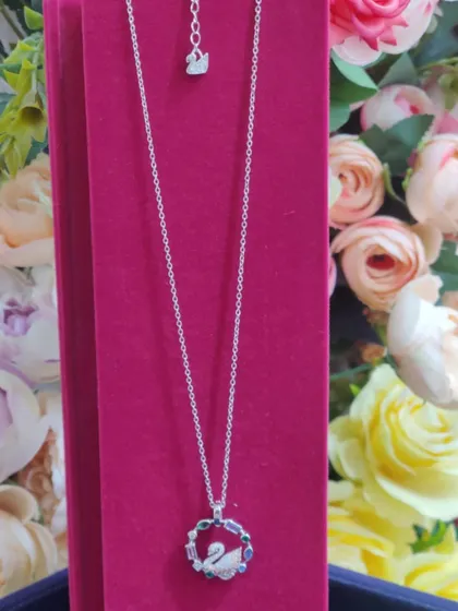 A stunning multi-colored crystal swan pendant, inspired by Swarovski designs, perfect for adding a touch of vibrant elegance.