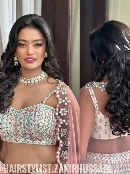 A beautiful Sangeet look with voluminous curls and a simple half-up twist, adorned with pearl pins.
