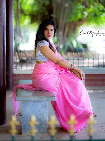 A vision in pink. This portrait, taken in a park, shows how a brightly colored saree can create a beautiful contrast with the natural green surroundings.