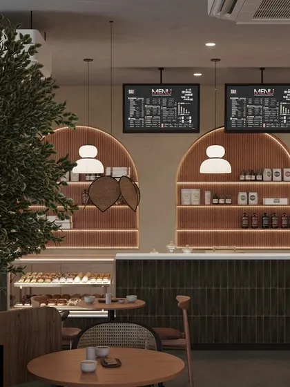 This shot shows the counter area in relation to the main seating. The arched, illuminated display shelves are a key design feature, drawing the eye and showcasing the cafe's products beautifully.