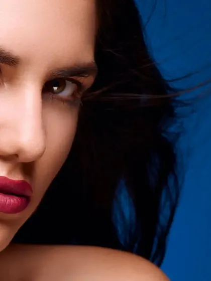 A close-up beauty shot that creates a sense of drama and intensity. The combination of the model's expression and the clean lighting makes for a powerful portrait.