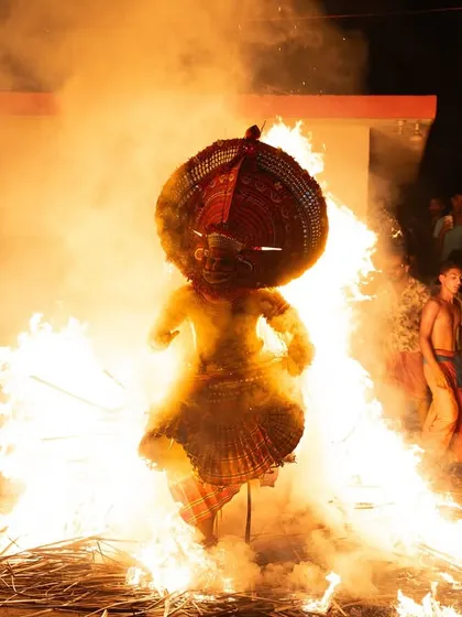 A sequence documenting the Kandanar Kelan Theyyam's fearless dance through fire. These images show the performer's complete surrender to the flames, a testament to the ritual's power.