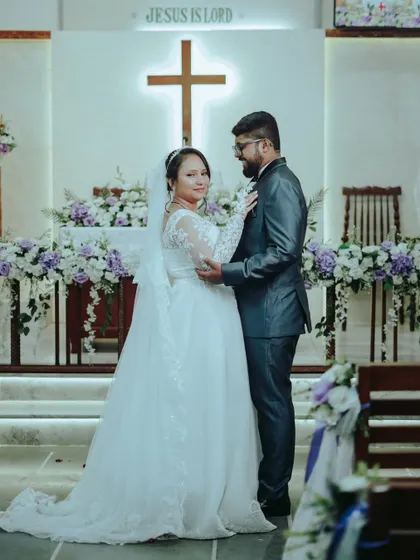 A classic portrait of the couple standing together in the church, ready to begin their journey as husband and wife.