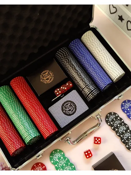A high-quality poker chip set in a durable carrying case. This set includes multiple colored chips, dice, and custom playing cards, making it perfect for hosting poker nights with friends.