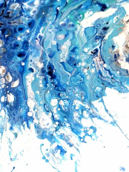 This detail shot shows the splash and spray of the wave, capturing a moment of intense energy.
