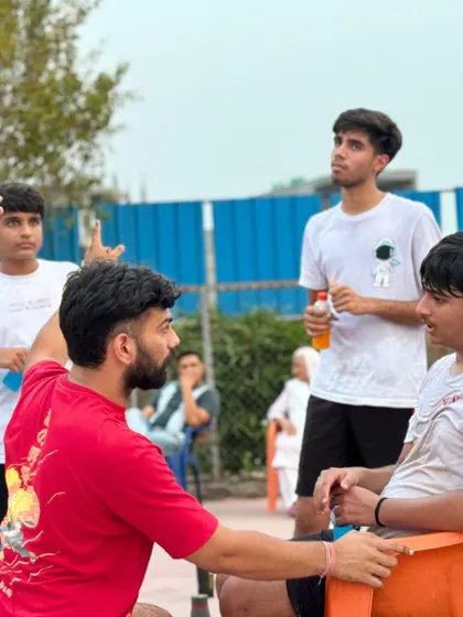 Discussing strategy with a player during a U-17 practice match. Individual feedback is key to player development.