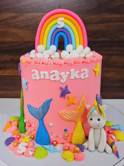 A cake combining mermaid tails, rainbows, and unicorns for Anayka's 5th birthday. This chocolate and nutella cake is a fantasy world of pure imagination.