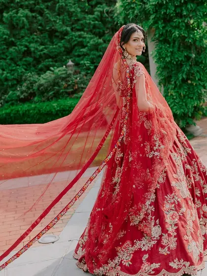 A look from the back can be just as breathtaking. The flowing red veil with its detailed border creates a beautiful sense of movement and grandeur.
