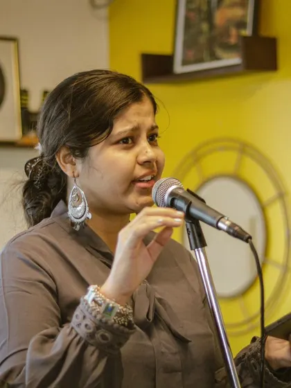 A proud moment from our student recital. A vocalist expresses herself with confidence and passion in front of a supportive audience.