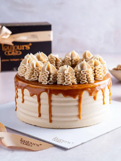 Our classic caramel drip cake, beautifully presented with a cascade of golden caramel over smooth buttercream. The top is adorned with swirls of buttercream, making it a simple yet stunning choice for any celebration.