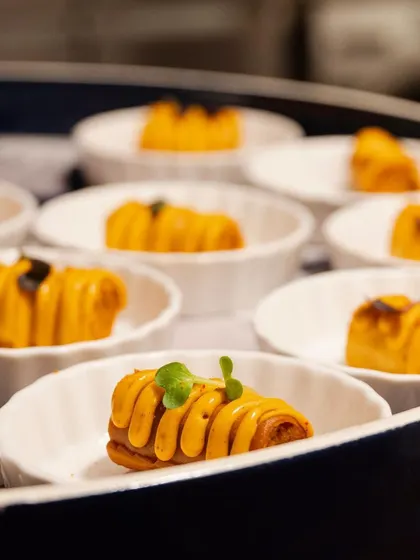 A tray of our signature rolled canapés, showcasing intricate presentation and modern flavors, ready to be served to guests.