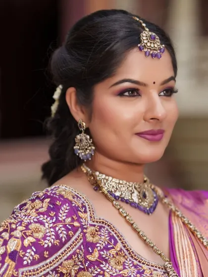 A close-up of the stunning purple hand-embroidered blouse, which can be rented separately to pair with your own saree.