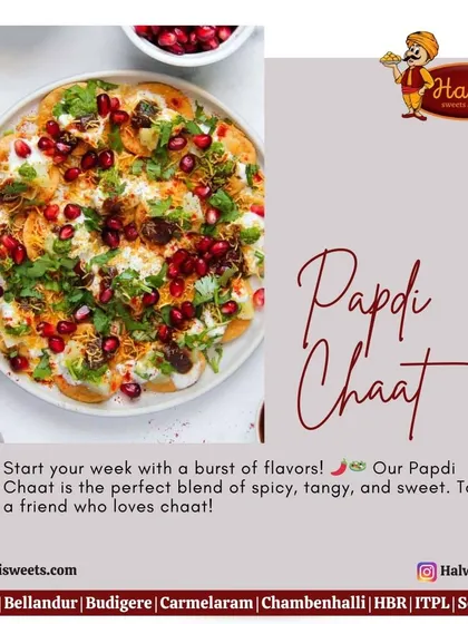 A close-up of my delicious Papdi Chaat, generously topped with creamy yogurt, tangy chutneys, fresh cilantro, and glistening pomegranate seeds for a burst of flavor.