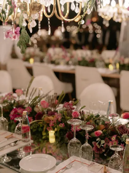 The art of celebration is in the details. This shot from a finale dinner shows our meticulous approach to tablescaping, where fresh floral arrangements, elegant glassware, and ambient lighting come together to create an unforgettable dining experience.