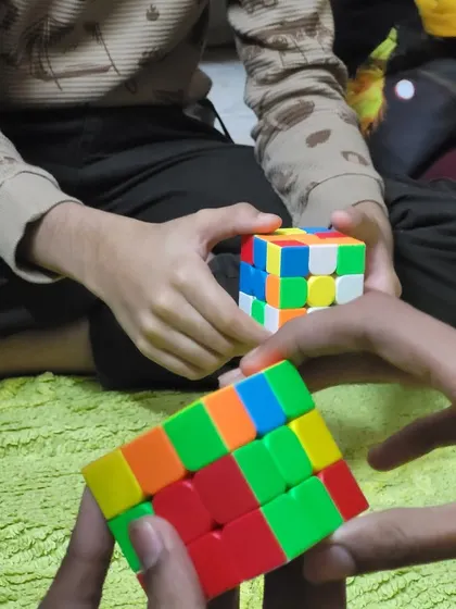 Hands and minds working together! The Rubik's cube is a fantastic tool for developing problem-solving skills, and it's even more fun when you're learning with friends.
