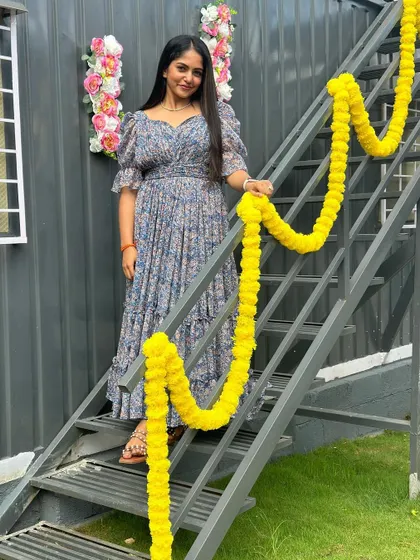 The client posing on a staircase, showing the versatility of the dress.