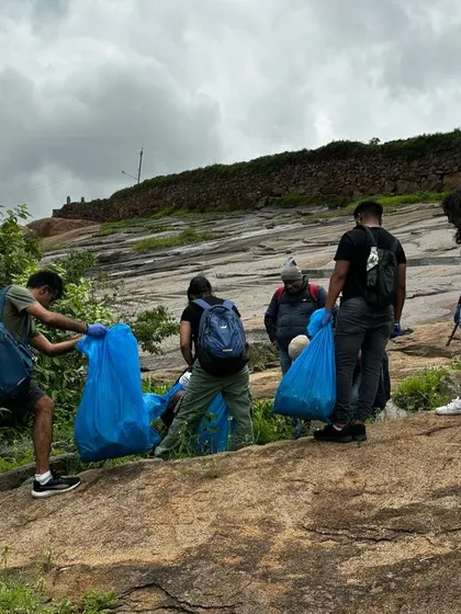 Participants gathering collected waste on the rocky slopes of Uttari Betta. We believe in and practice the principles of "Leave No Trace" on all our treks.