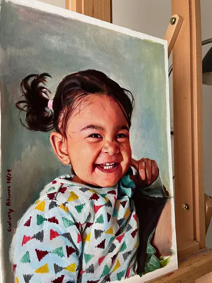 The same oil portrait of my daughter, shown on an easel in my studio. This gives a sense of the painting's scale and presence in a room.