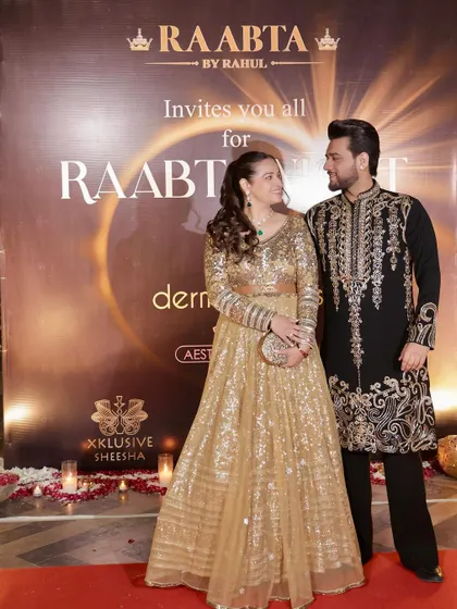 A beautiful couple's portrait. Our black and gold embroidered kurta complements the festive attire of his partner, making them a picture-perfect pair at this Diwali event.
